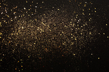 Fototapeta na wymiar Golden glitter sparkle or stars on black background.