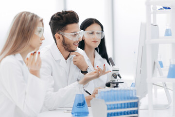 close up.a team of scientists use a computer to check the data