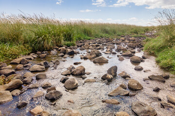Shallow river Daliyot flowing near the remnants of the early Bronze Age megalithic complex of the...