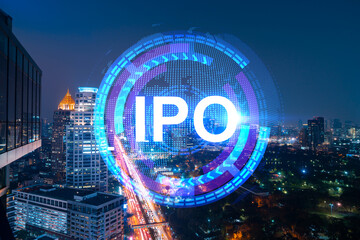 Initial public offering hologram, night panoramic city view of Bangkok. The financial center for multinational corporations in Asia. The concept of boosting the growth by IPO process. Double exposure.
