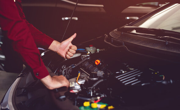 The car mechanic is checking the availability of a good, safe driving companion. Picture for your business