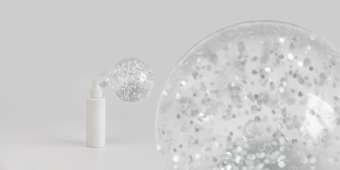 Hand sanitizer cosmetic bottle on gray background with copyspace and bubbles. New normal concept. Natural, beauty body health cosmetic products.