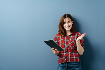 Friendly young woman holding a tablet pc