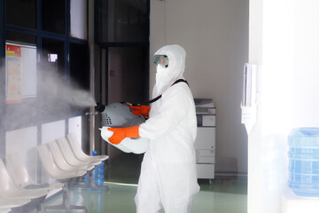 Medical staff spraying chemicals to kill the covid-19 virus.