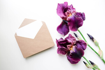 postcard mockup. purple iris flowers and an envelope. space for text. congratulation. invitation