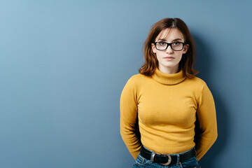 Serious intense young woman wearing eyeglasses