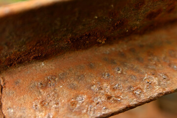 Macro Photo of an old metal corner damaged by rust and corrosion.