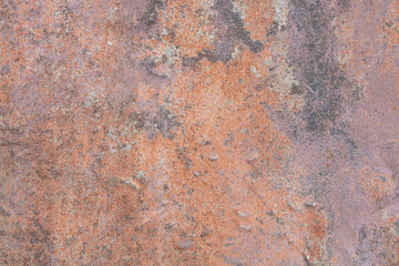 Rusty metal surface with gray, brown and orange paint flaking and cracking texture. Multicolored background. 