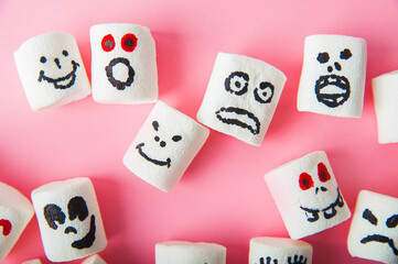 Marshmallows close-up and copy space on a pink background. Marshmallows for Halloween emoticons.