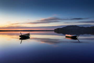 Parking for small fishing boats on the lake during sunset. Beautiful background for cards