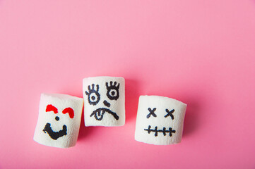 Marshmallows close-up and copy space on a pink background. Marshmallows for Halloween emoticons.