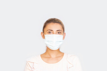 Portrait of a woman adult young in a medical mask on an isolated background