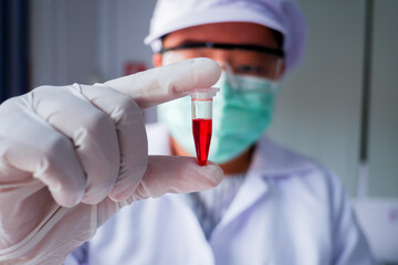 The cropped shot view of the Scientist researching, developing and testing the virus vaccine with human's blood sample.