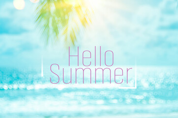 Hello summer words on blur tropical beach with bokeh sunlight wave abstract background. Summer vacation and travel holiday concept.