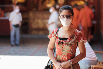 young Asian girl wearing Protective face mask protect coronavirus inflection, Happy tourist woman...