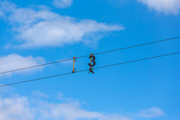 Number 3 on a background of blue sky with white clouds