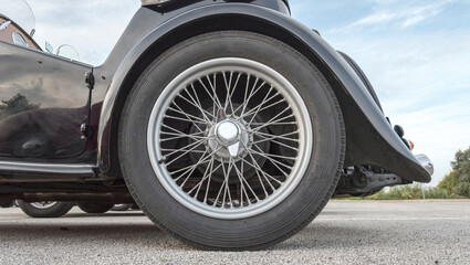 wheel with spokes of an ancient convertible car