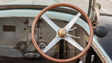 Old wooden steering wheel and metal of an old Italian car