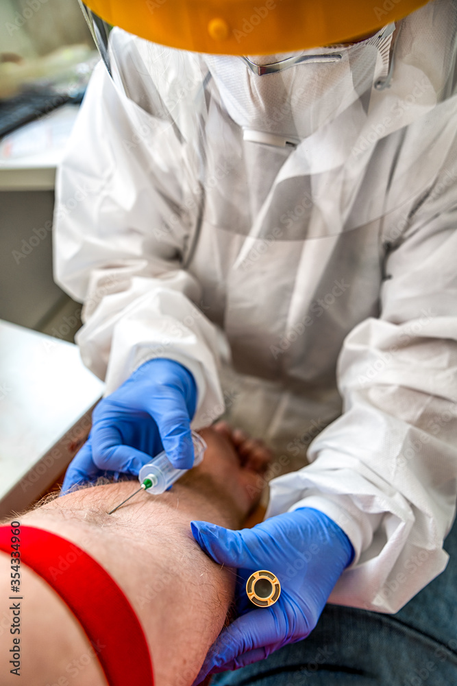 Wall mural Blood sampling with medic in protective suit. Test for detection of antibodies