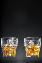 Glass of whisky on black background, copy space