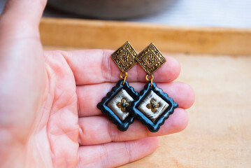 Fototapeta premium Gold Black bohemian earrings. Handmade jewelry design.
