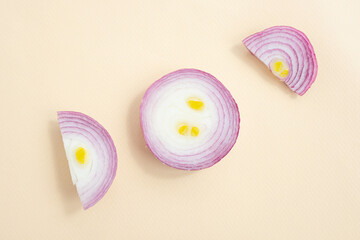 Red sliced onions on a light pastel background. The concept of healthy vegetables. Textural food background.