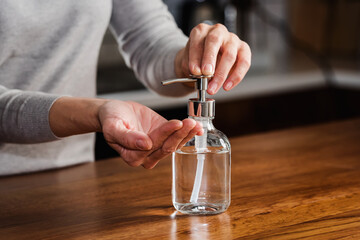 Closeup of woman hands using hand sanitizer liquid for bacteria and virus neutralization. Keep your hands germ-free and virus free with the use of hand sanitizer. Personal Protective Equipment for Inf