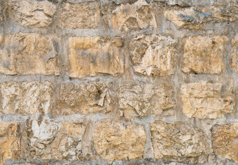 Medieval ancient stone wall in old Jerusalem seamless texture background.
