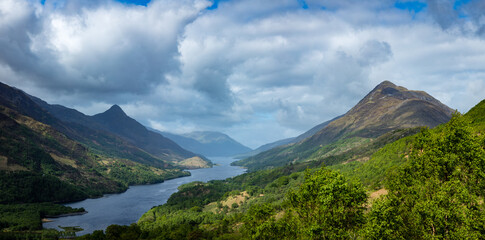 Naklejka na ściany i meble a view over loch leven from the west highland way near kinlochleven and fort william in the argyll region of the highlands of scotland during a warm spring day showing green forest and hillsides