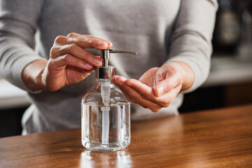Closeup of woman hands using hand sanitizer liquid for bacteria and virus neutralization. Keep your hands germ-free and virus free with the use of hand sanitizer. Personal Protective Equipment for Inf