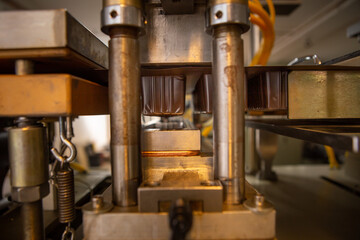 Vacuum press for shaping plastic packaging and a box that has just been shaped. Industry. Packaging.