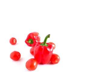 Red sweet peppers and tomatoes on a white background. Suitable for mockups and backgrounds. Food preparation. Vegetables.