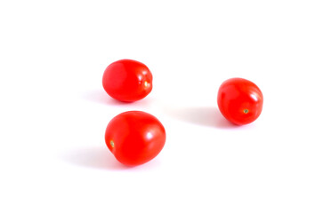 Red tomatoes on a white background. Suitable for mockups and backgrounds. Cooking. Vegetables.
