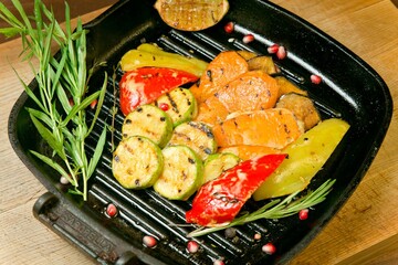 Assorted grilled vegetables with fried lemon. On a wooden tray
