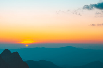 Obraz premium Sunset or evening time with half of sun with clouds at Doi Luang Chiang Dao, Chaingmai, Thailand. Asia.