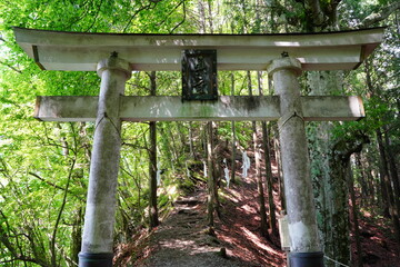 Shinto shrine gate "Torii" of "Mitsumine Jinja Shrine Okumiya" at the top of Myohogatake mountain in Chichibu, Tokyo, Japan. Japanese test on the gate is "Okumiya"(Rear shrine).