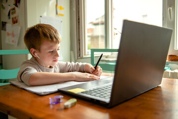 Young boy learning at home during quarantine