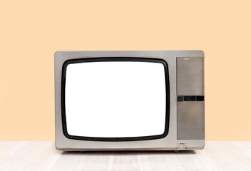 Retro old television cut out screen on table in front of wall background. Vintage old TV with clipping path