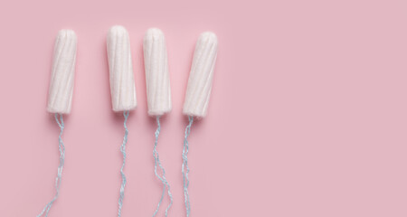 Menstruation. Tampons on a pink background. Copy space