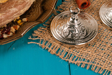 Turkish metal tableware on wooden table close up