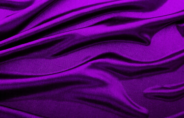 Fototapeta na wymiar Texture of purple fabric in waves.