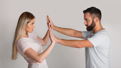 Confronting home repressor. Man presses woman with his hands, girl resists