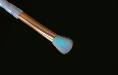 Colorful makeup brush on black background.Copy space