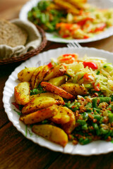 Food on a plate. Delicious and delicious homemade lunch: fried potatoes, string beans and a portion of salad. Top view