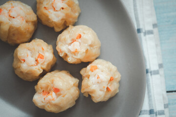 Group of hot steam shrimp dumpling served on gray dish