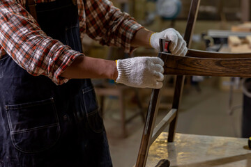 Asian carpenter man work and repair wood craft DIY at home ,portrait of happy attractive hardwork professional worker.