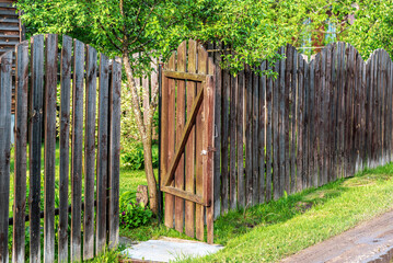 Open gate in a wooden fence