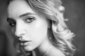 Fototapeta premium Monochrome portrait of serious sexy glamour woman wearing in elegant black lingerie. Woman looking in camera