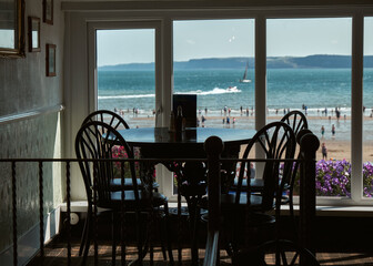 A silhouette view of restaurant window near beach and ocean, UK