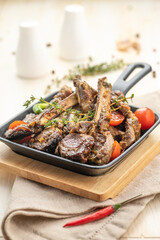 Fried lamb chops with fried onions, garlic and fresh herbs.